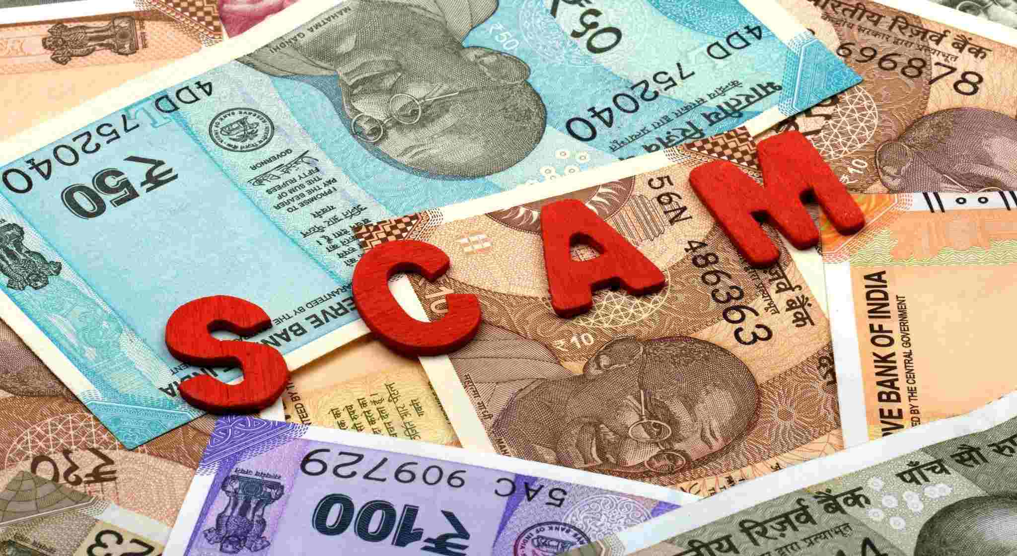 Indian Currency with Scam Word, Investment Scam.